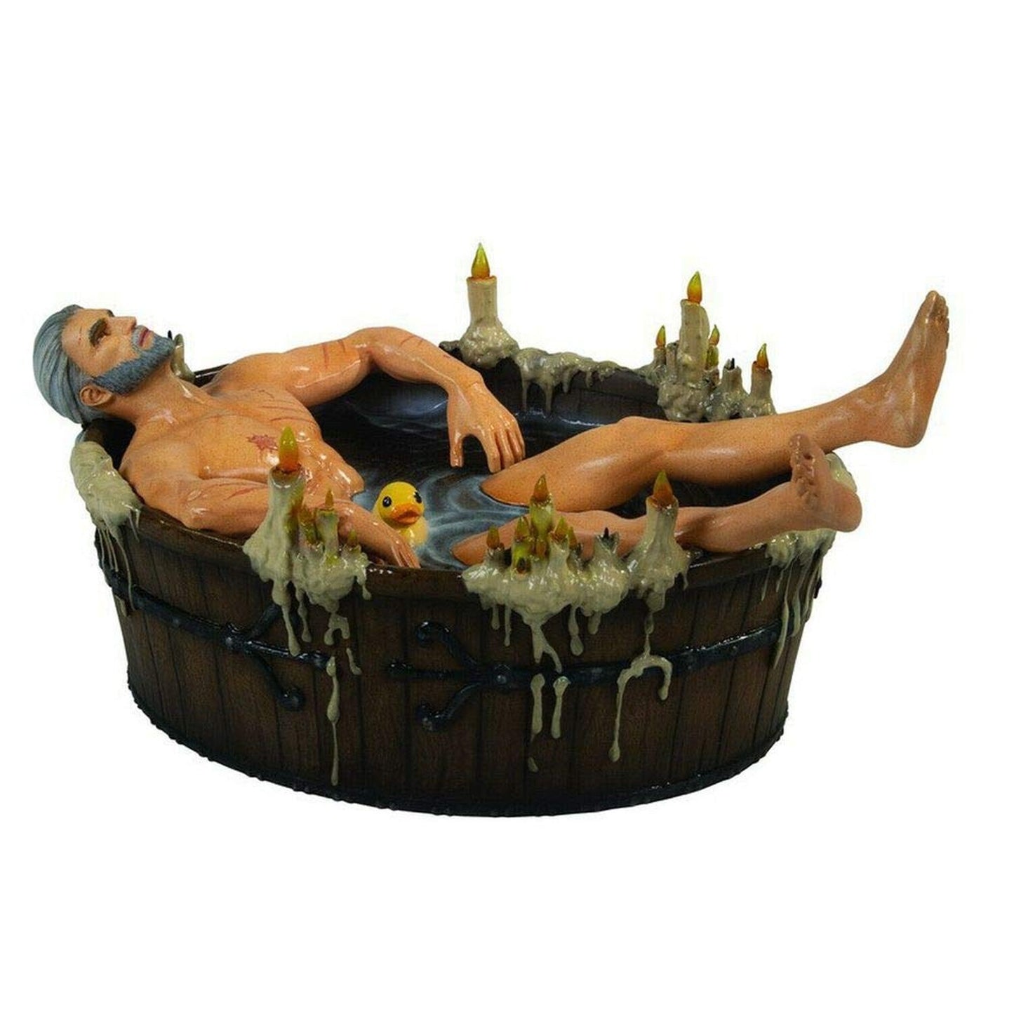 Geralt of Rivia figurine relaxing in a wooden tub with a rubber duck and many dripping candles