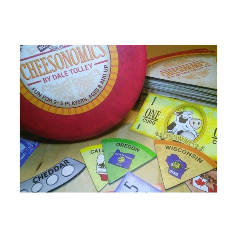 Red and yellow Cheesonomics board game box with card illustrations including a cow and maps of Oregon and Wisconsin
