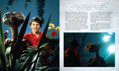ET the Extra-Terrestrial and Elliott in a lush green environment with the movie book detailing their story