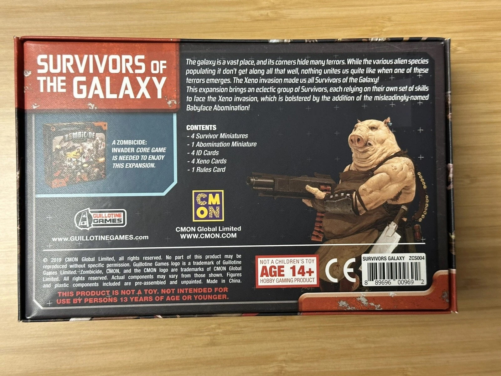 Back of "Survivors of the Galaxy" game box - a muscular, anthropomorphic pig alien holds a large futuristic shotgun