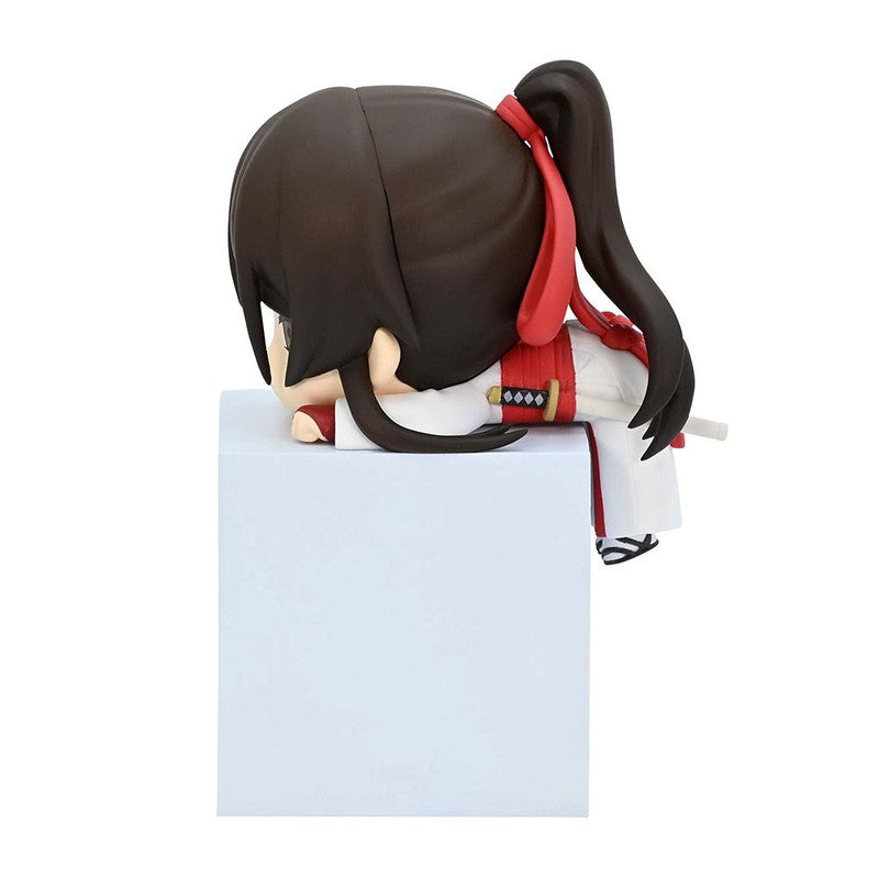 Chibi anime figure with dark brown hair tied in a ponytail wearing a white robe with red accents