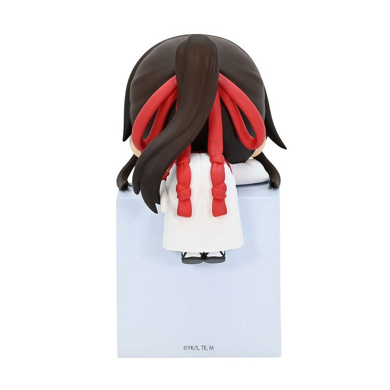 Chibi anime girl figure from behind wearing a white dress and red ribbons in her dark hair