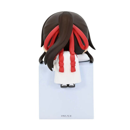 Chibi anime girl figure from behind wearing a white dress and red ribbons in her dark hair