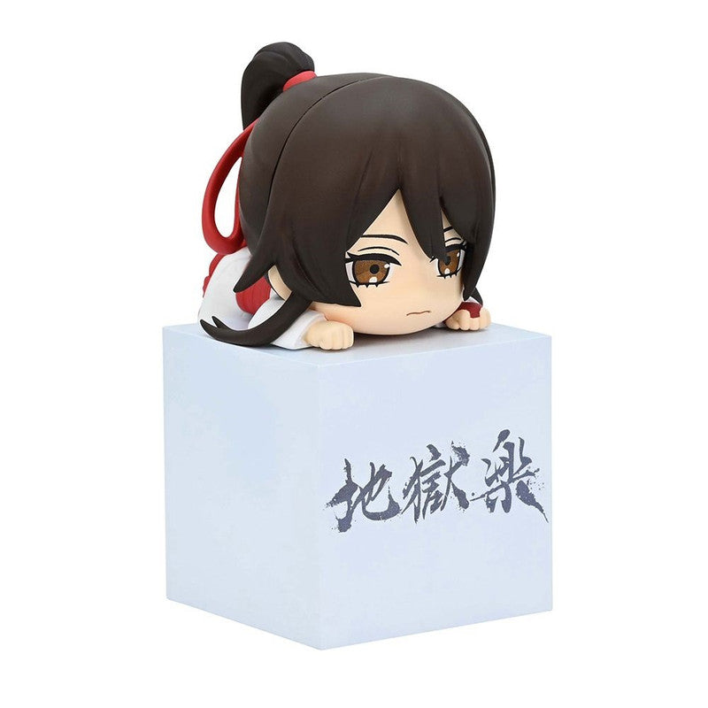 Chibi anime figure of a character with brown hair in a ponytail wearing a white top with red accents kneeling on a white block