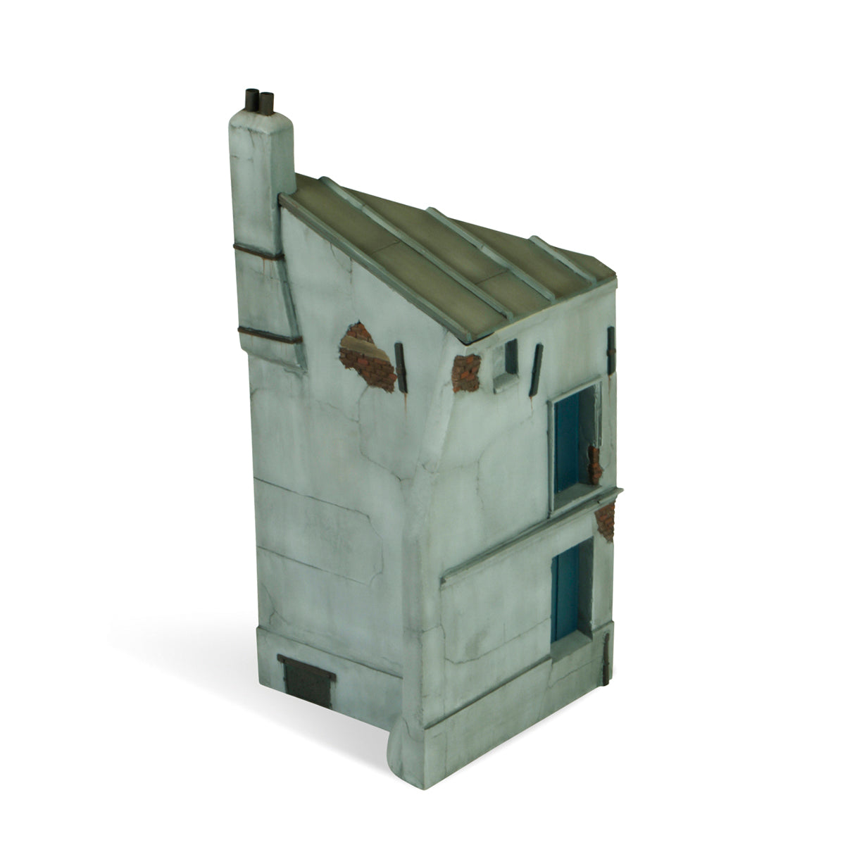 Vallejo Scenics Bases French House Corner, a miniature model of a distressed, light grey building with cracked walls, exposed brick, a chimney, and a sloped roof