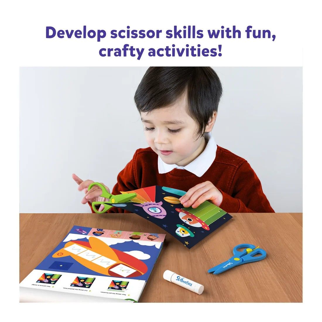 Child practices cutting skills with green safety scissors and a craft activity sheet