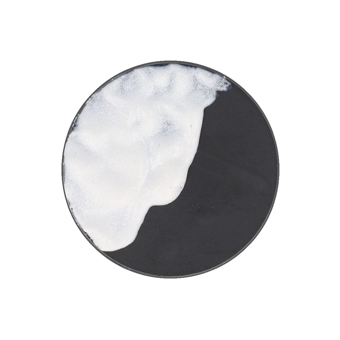 A black circular dish partially covered with white, bubbly foam.