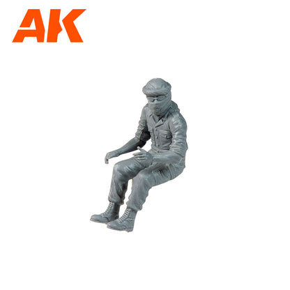 AK Interactive gray model figure of a person in desert-style uniform -  headscarf -  and sunglasses -  seated