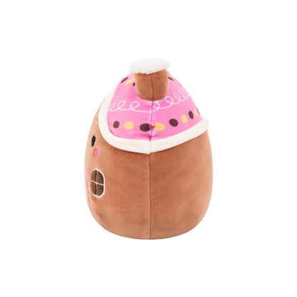 Brown plush gingerbread house toy featuring a pink, sprinkled roof and white trim