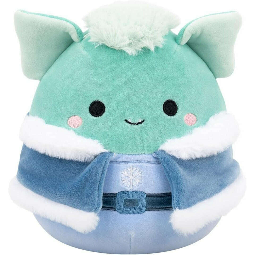 Teal plush creature in a blue, fur-trimmed winter cape with a belt and snowflake design