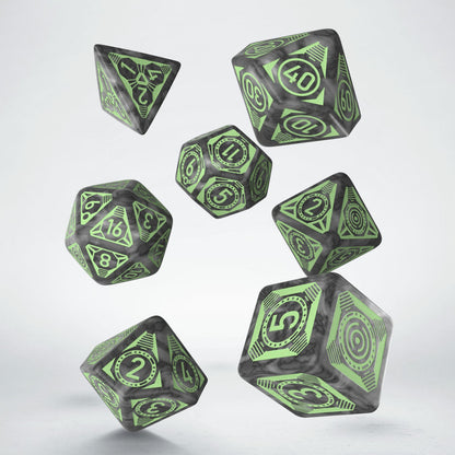 Seven dark gray marbled Q Workshop Pathfinder Mummy's Mask dice with light green numbers and symbols float in the air