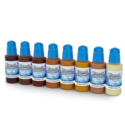 Nine dropper bottles of 'Fantasy & Games' paints line up. Colours range from dark brown to light yellow, each with a blue cap.