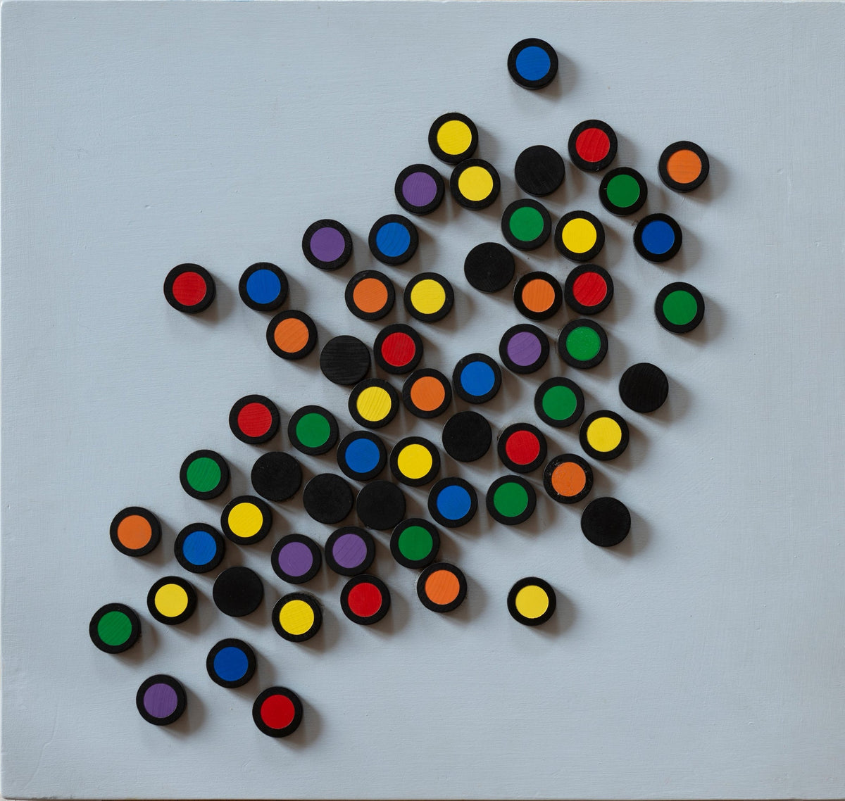 Close-up of hands interacting with Colomo game pieces, showing gameplay in action