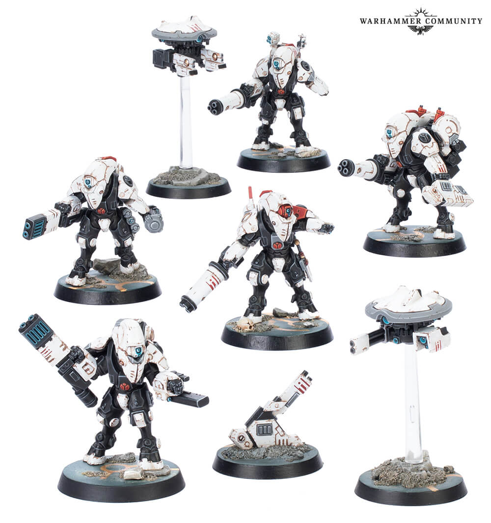 Detailed squad of white and black T'au Battlesuit and Drone miniatures from Warhammer 40K