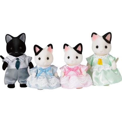 A set of four flocked cat toy figures (a black father, white mother, and two kittens) dressed in formal clothing
