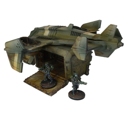 Detailed miniature of a weathered green sci-fi dropship with its ramp open, two armored soldiers disembarking