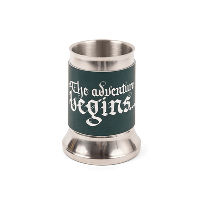 Stainless steel mug with a navy blue tankard wrap featuring white calligraphic text: "The adventure begins..."