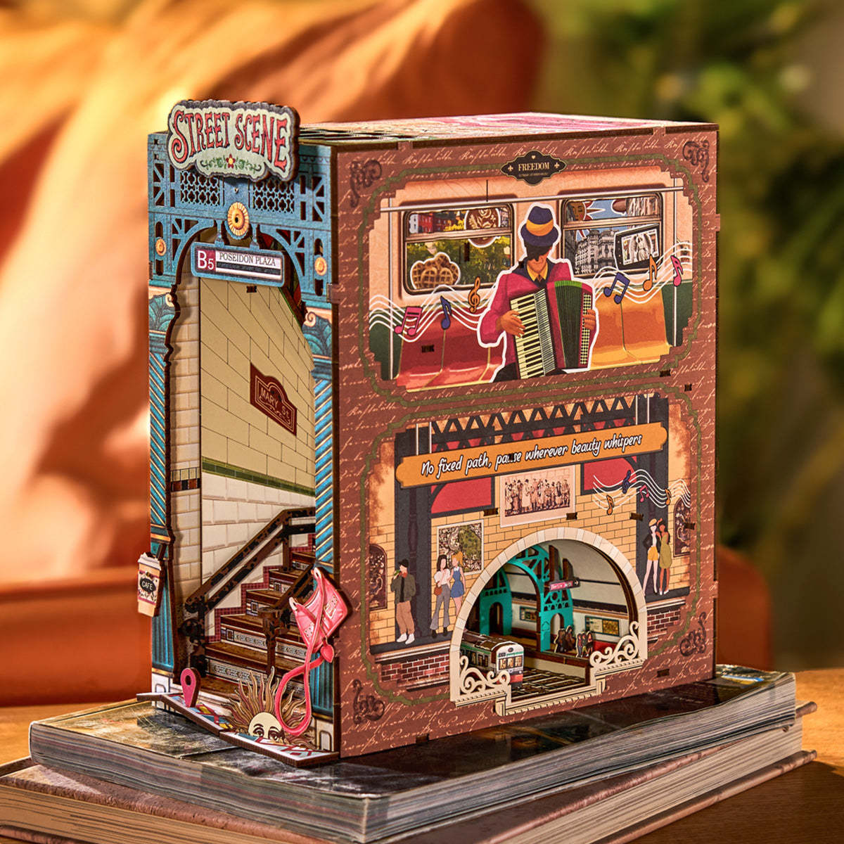 Detailed wooden book nook diorama depicting a layered subway station entrance and an accordion player