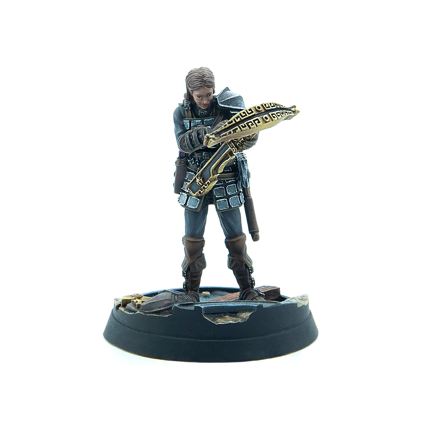 Miniature female warrior in armor holds an ornate golden crossbow