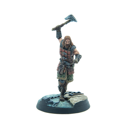 Hand-painted miniature of a bearded male warrior in segmented armor, axe raised, roaring on a rocky base