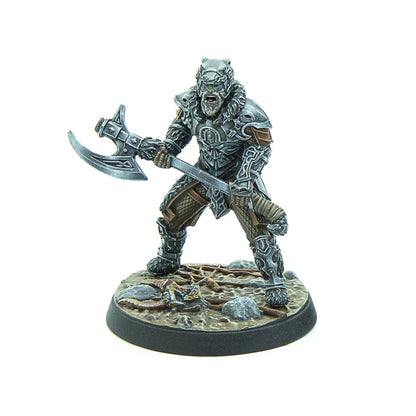 Painted miniature of a snarling, armored orc-like warrior with green skin, holding a large battle axe