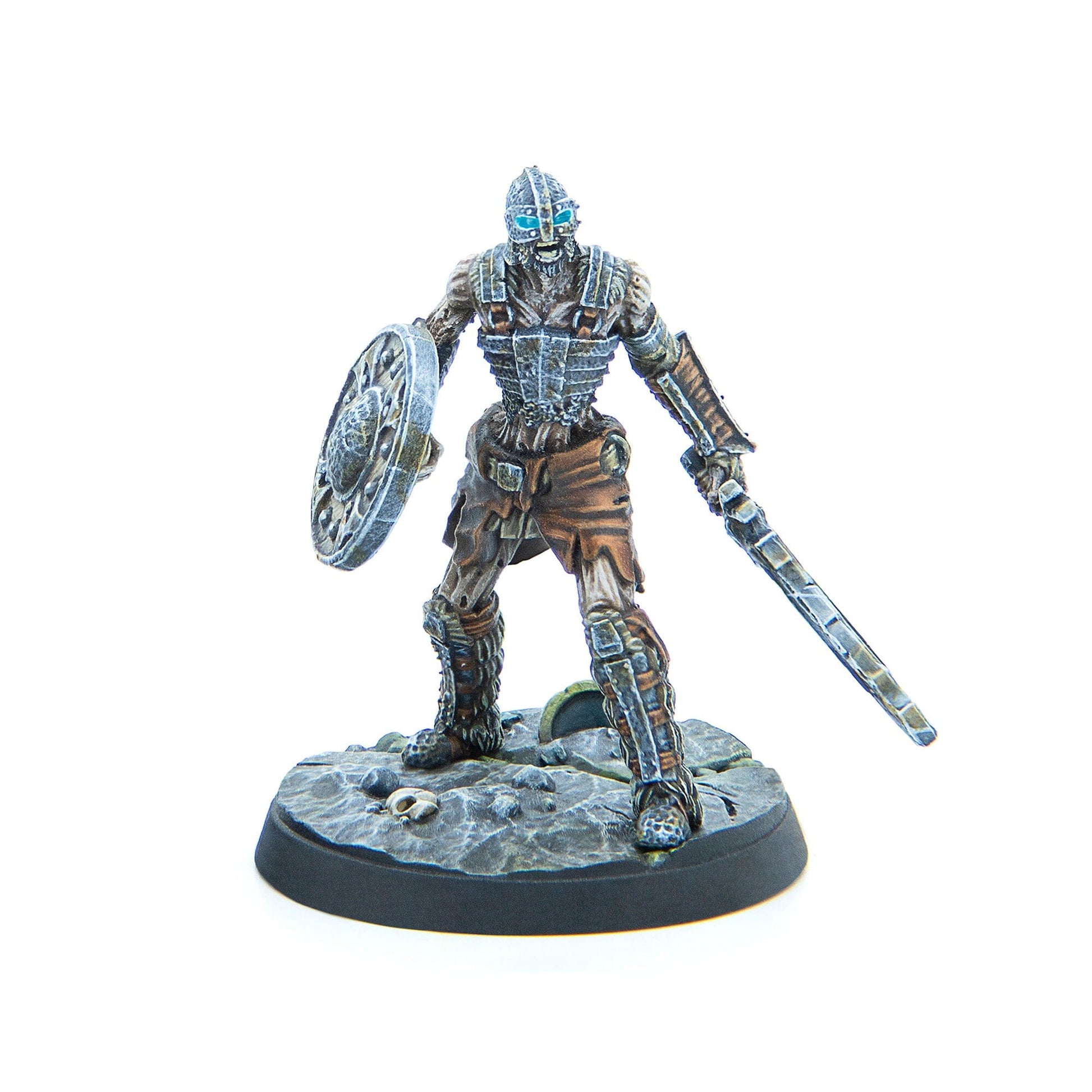 Miniature skeletal warrior with glowing blue eyes, wielding a round shield and sword, stands on a rocky base