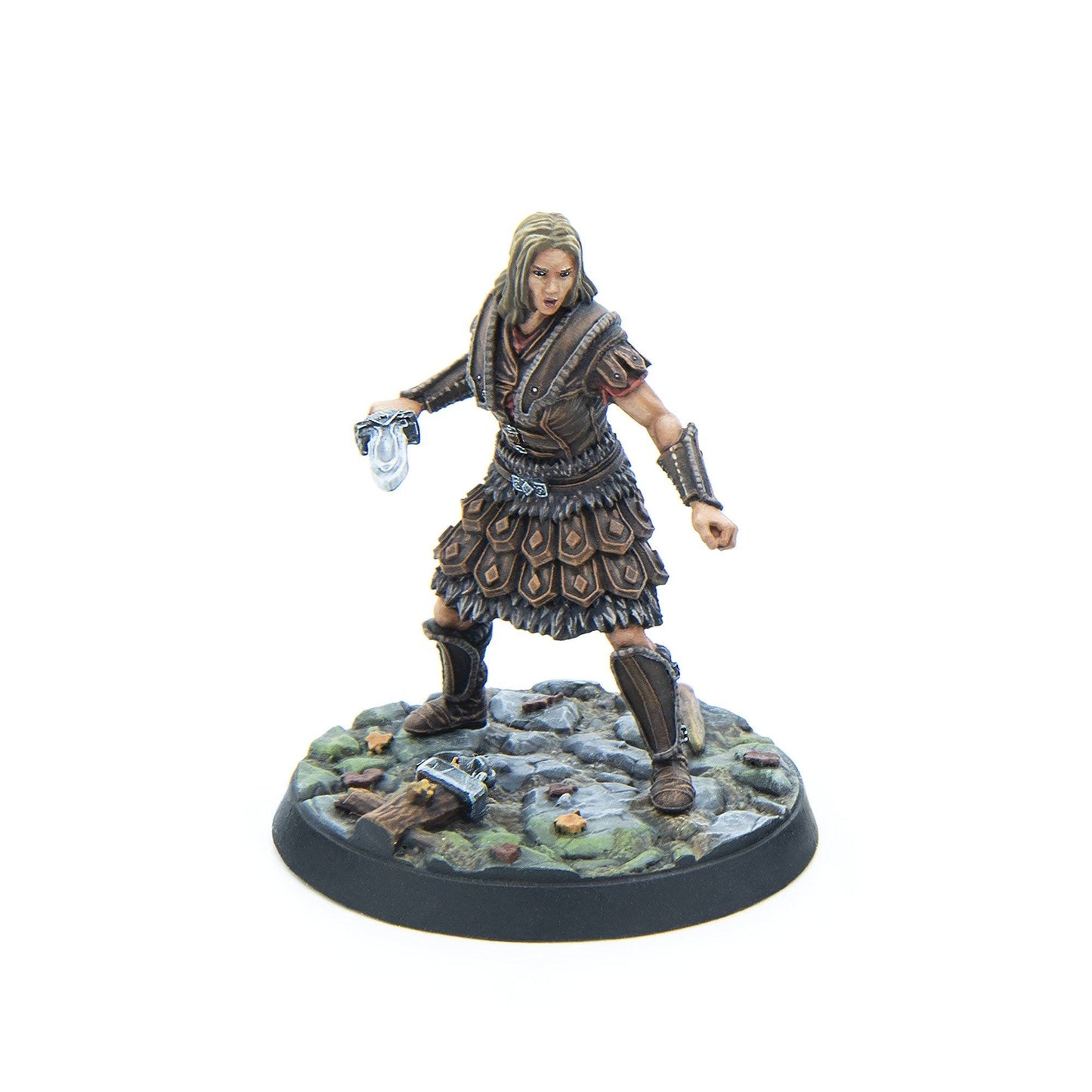 Painted miniature of a blonde female warrior in brown leather armor, holding a dagger, poised on a rocky base