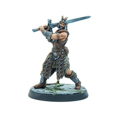 Tabletop miniature of a bearded warrior in horned helmet and fur armor, wielding a two-handed sword over his head.