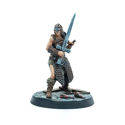 Miniature female warrior in fur and leather armor, helmeted, wielding a large ornate sword. Broken vials lie on the base.
