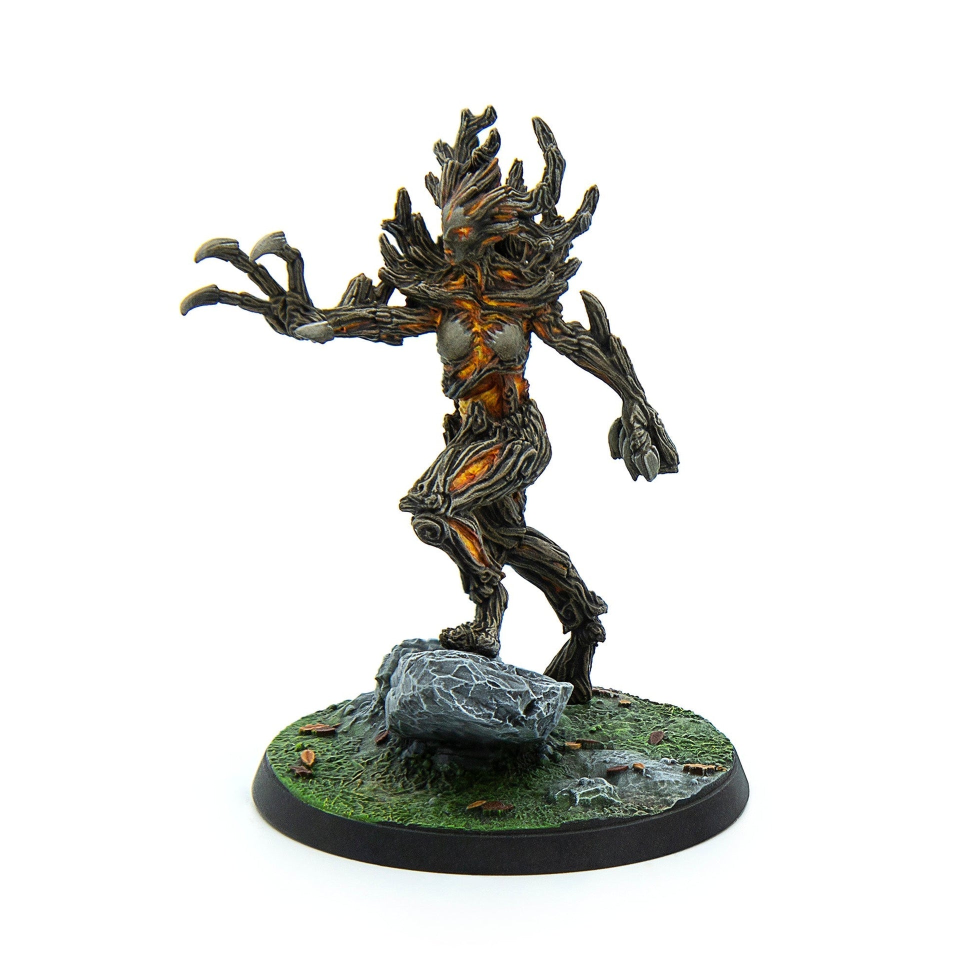 Treant miniature with dark bark and glowing orange core, stepping on a rocky base