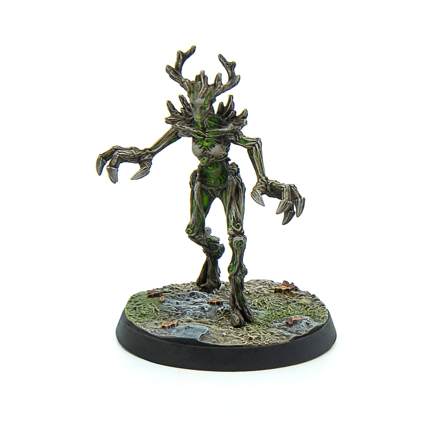 A menacing tree creature miniature with glowing green veins, sharp claws, and antlers steps forward on a textured base