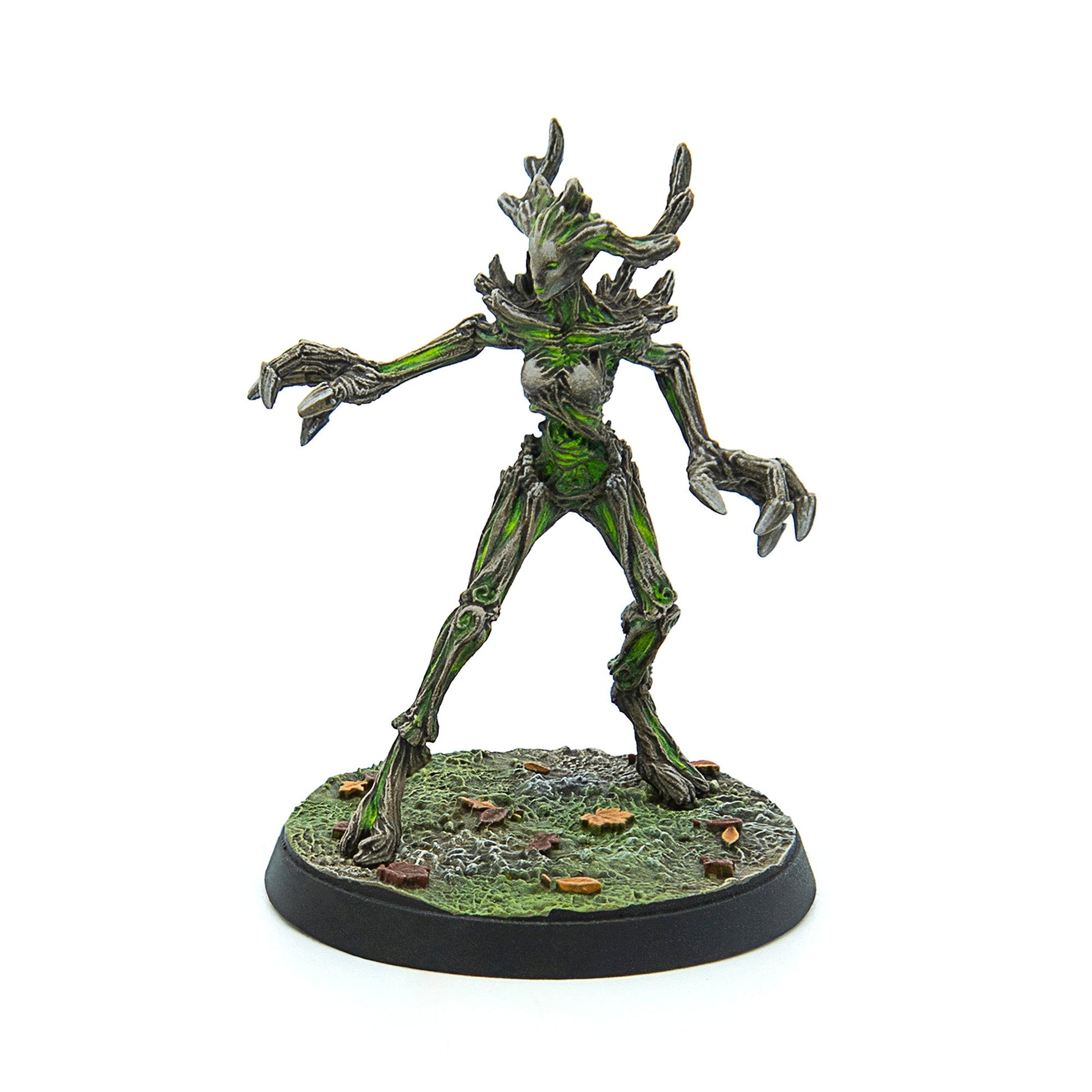 A tree-like fantasy miniature with bark skin, vibrant green highlights, and clawed hands, standing on a textured base