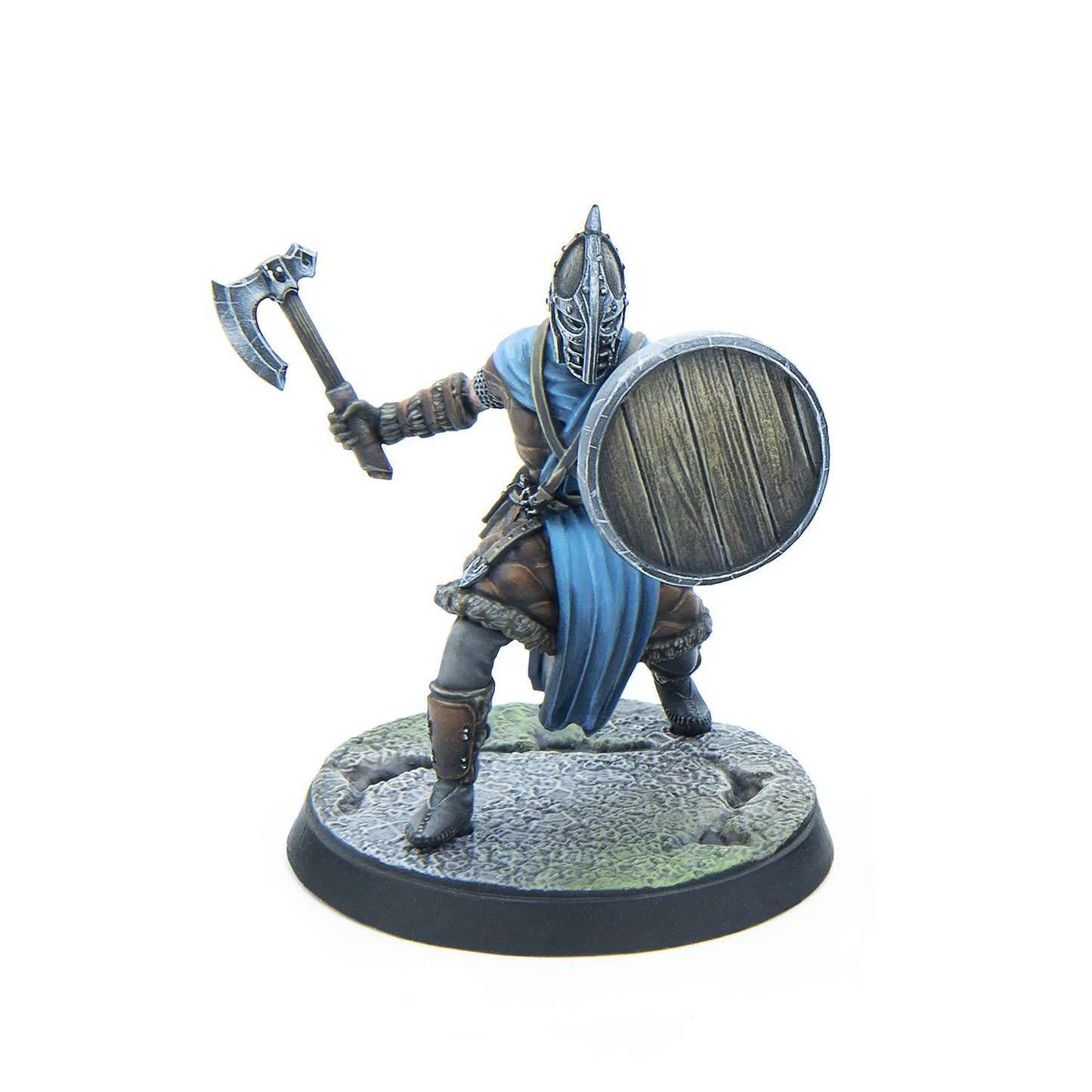 Miniature fantasy warrior in helmet and fur armor, wielding an axe and round wooden shield, ready for battle