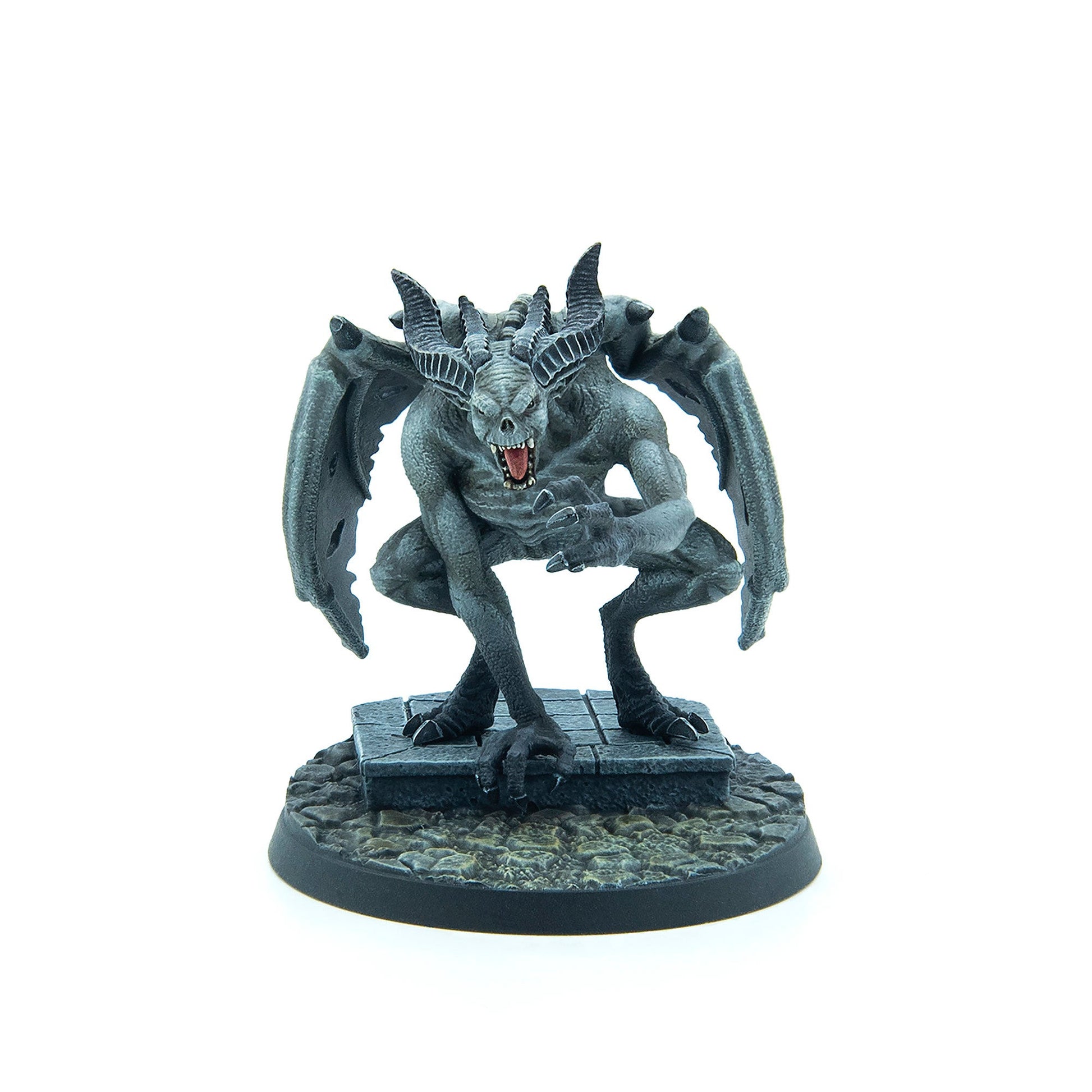 Grey gargoyle miniature with large horns, bat wings, bared fangs, and claws, crouching on a stone base