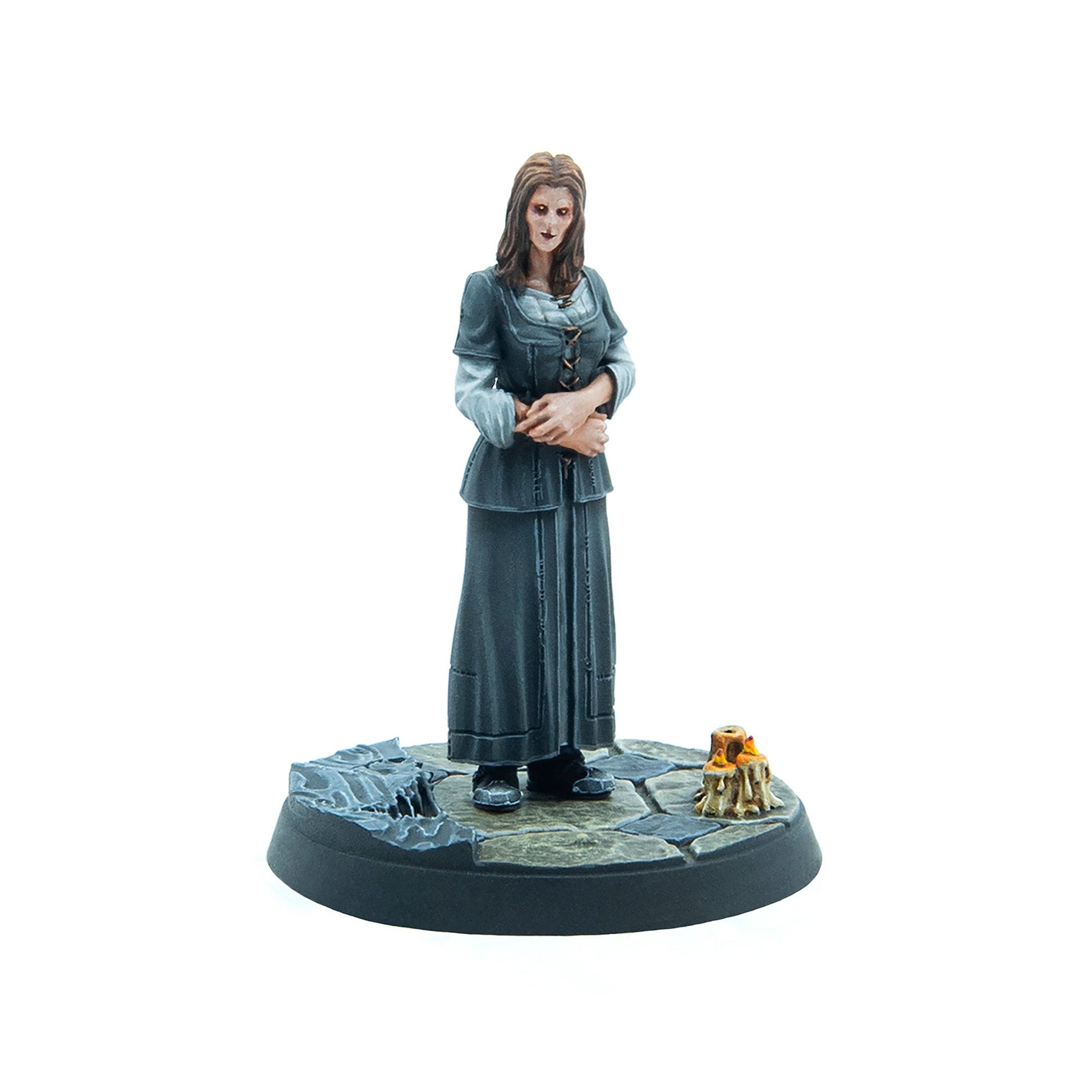 Miniature of a pale, dark-eyed woman in a dark grey dress, hands crossed, on a stone base with lit candles