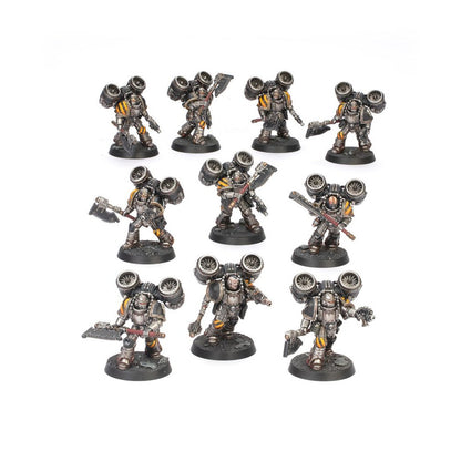 Nine miniature Space Marine figures with jump packs and axes, painted silver and yellow, on a white background