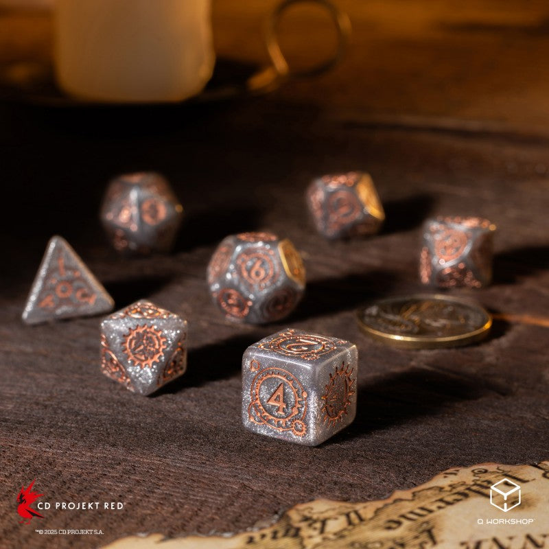 Steampunk-themed metallic polyhedral dice set, silver with copper details, scattered on a dark table beside a map