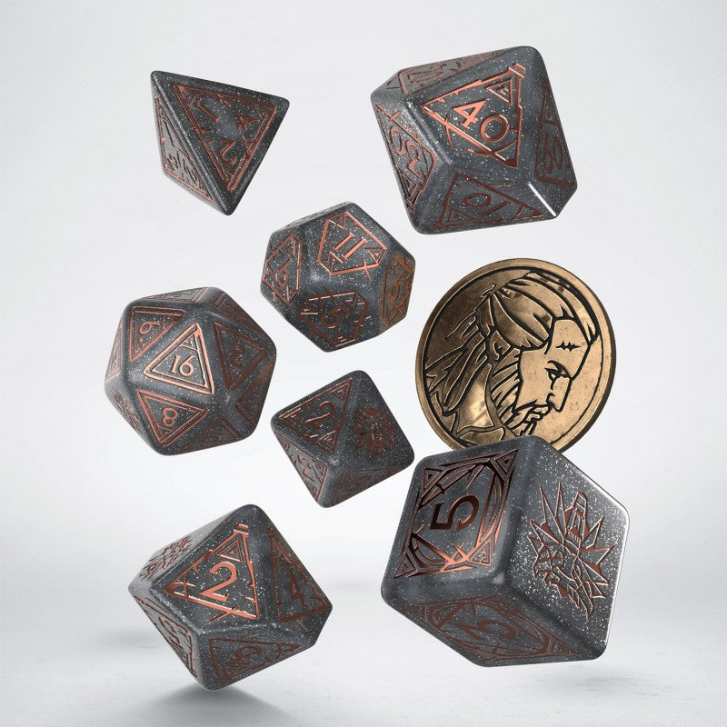 Seven dark grey polyhedral dice with copper numbers and a bronze coin with a bearded face float