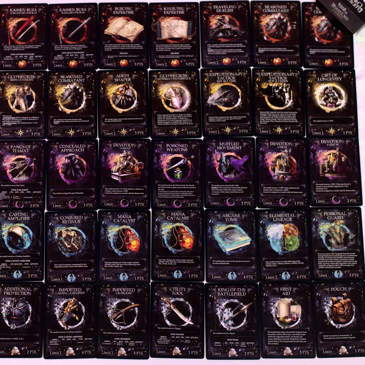 Dozens of dark fantasy game cards with vibrant illustrations and text arranged in rows.
