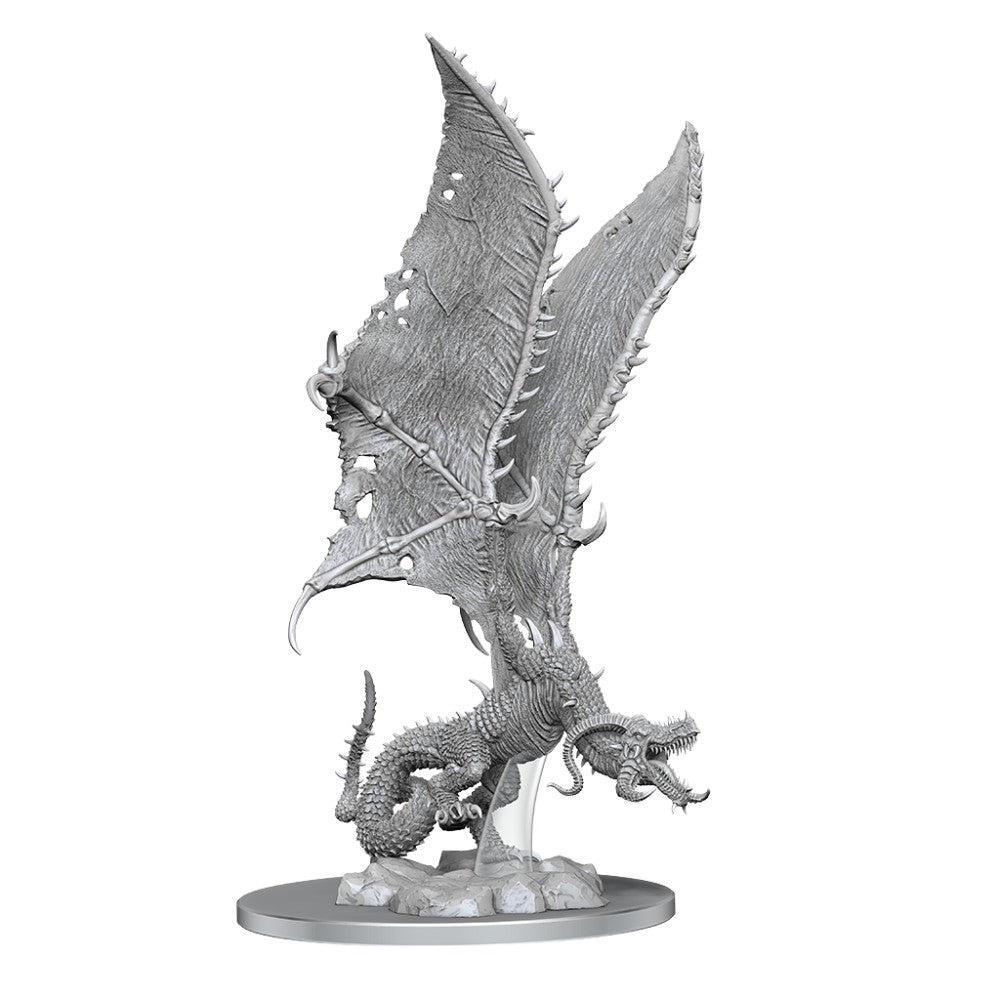 An unpainted 'Flame Drake'  miniature with torn wings and bared teeth, poised on a rocky base