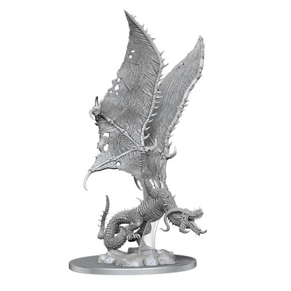 An unpainted 'Flame Drake'  miniature with torn wings and bared teeth, poised on a rocky base