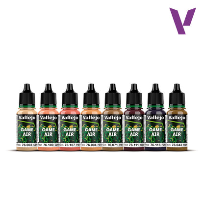 Eight Vallejo Game Air dropper bottles of paint in various flesh, peach, red, purple, and brown shades