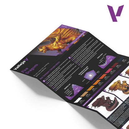 A folded Vallejo "Fire Dragons" guide with an orange dragon illustration, painting techniques and color swatches