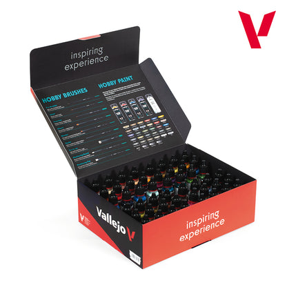 An open retail display box, red and black, filled with numerous small bottles of vibrant hobby paint, with product details and color swatches on the inner lid