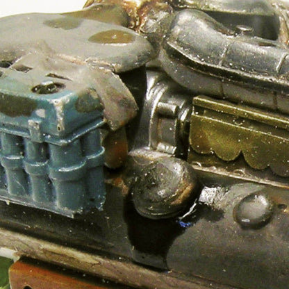 Weathered tank details: grimy metal, blue containers, and golden components