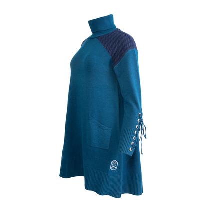 Teal turtleneck sweater dress with dark blue cable-knit shoulders, lace-up sleeve, and front pocket