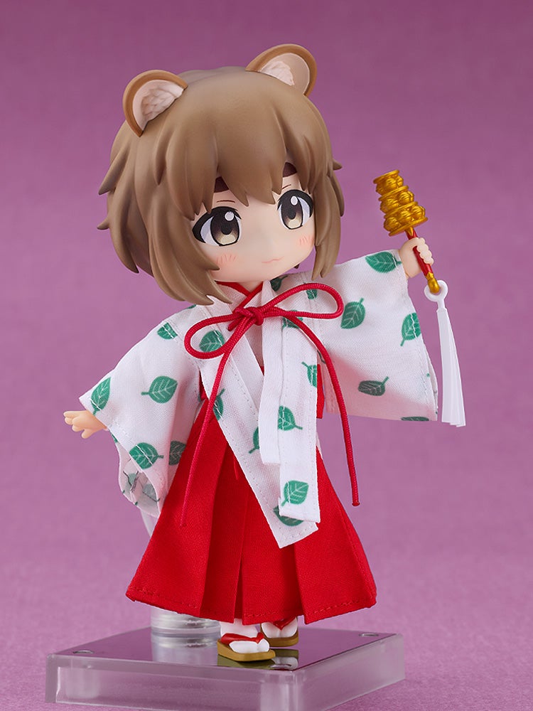 Tanuki Miko Yui holding ritual bells with a joyful face