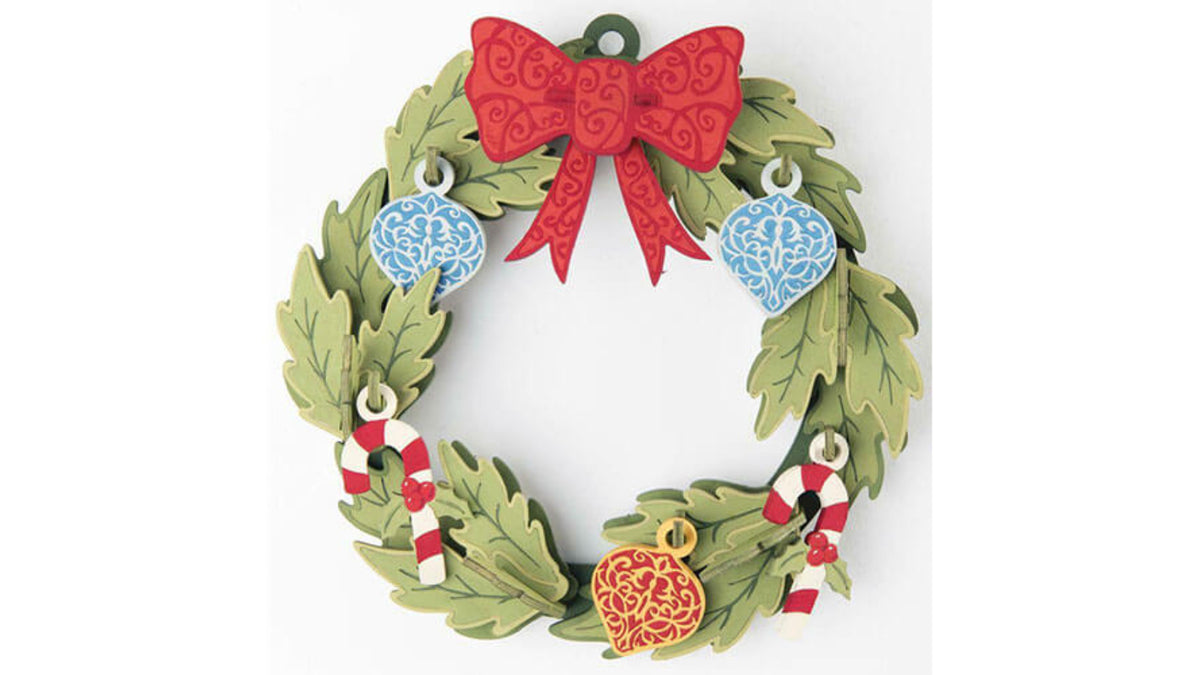 Incredibuilds 3D wood puzzle of a green leaf Christmas wreath with red bow, blue ornaments, and red and white candy canes