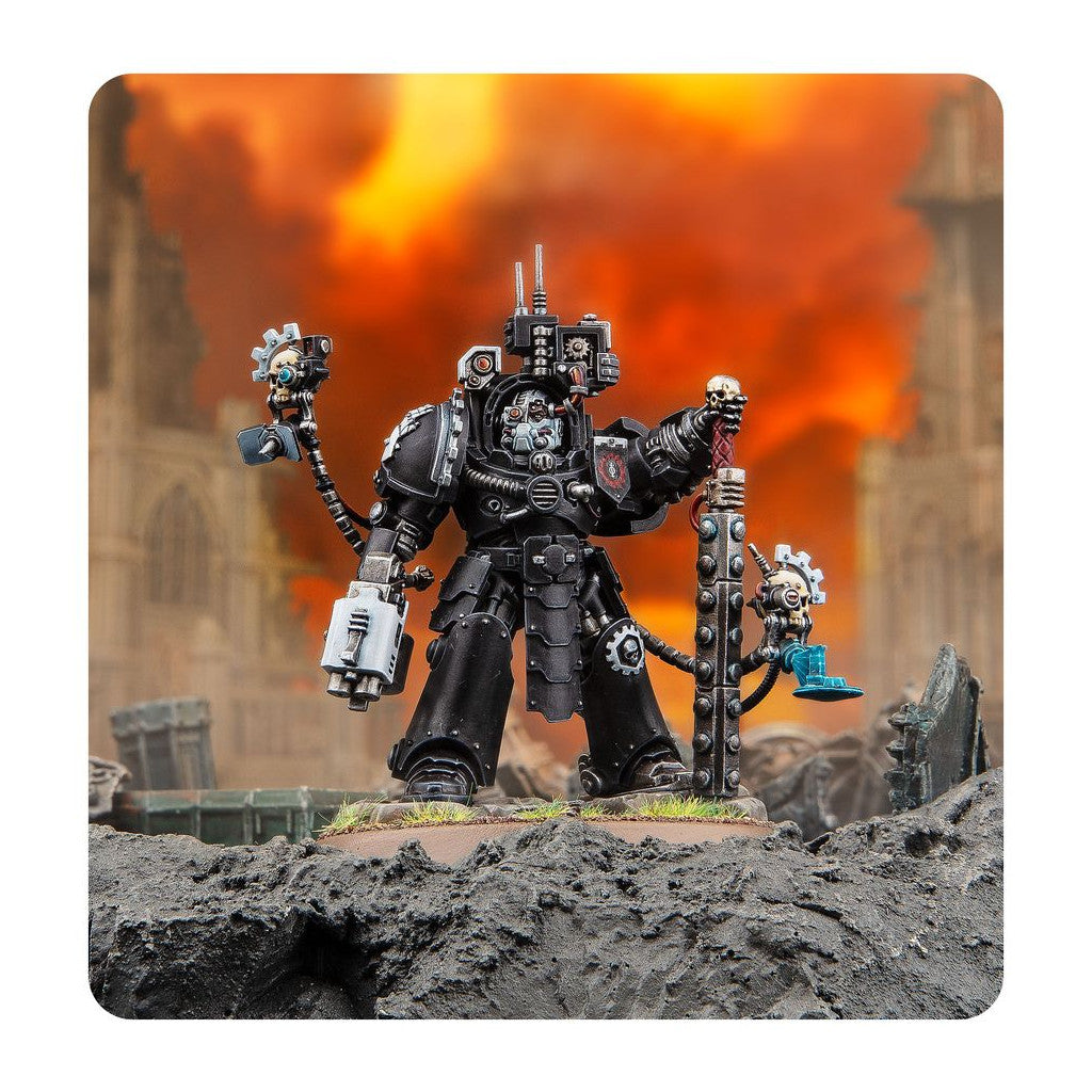 Miniature of a heavily armored black warrior (Techmarine) holding a skull-staff, standing on ruins with a fiery orange sky