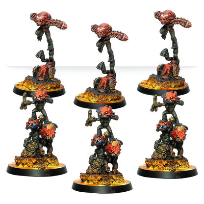 Six painted demonic miniature figures: three floating red Horrors and three stacks of smaller daemons on fiery bases